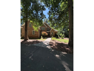 This beautiful brick home is nestled along the 14th hole of on Indian Trace Golf Course in Georgia - for sale on GolfHomes.com, golf home, golf lot