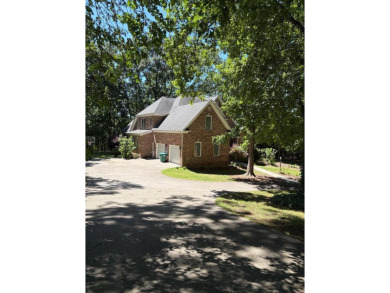 This beautiful brick home is nestled along the 14th hole of on Indian Trace Golf Course in Georgia - for sale on GolfHomes.com, golf home, golf lot