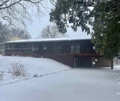 Cozy up to the crackle of the real wood fireplace in this home on Lake McBride Golf Course in Iowa - for sale on GolfHomes.com, golf home, golf lot