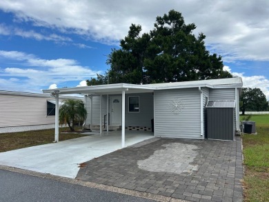 THIS TWO BEDROOM TWO BATH HOME SITS ON THE GOLF COURSE WITH A on Silver Dollar Golf and Trap Club in Florida - for sale on GolfHomes.com, golf home, golf lot