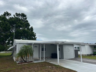 THIS TWO BEDROOM TWO BATH HOME SITS ON THE GOLF COURSE WITH A on Silver Dollar Golf and Trap Club in Florida - for sale on GolfHomes.com, golf home, golf lot