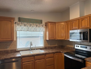 THIS TWO BEDROOM TWO BATH HOME SITS ON THE GOLF COURSE WITH A on Silver Dollar Golf and Trap Club in Florida - for sale on GolfHomes.com, golf home, golf lot