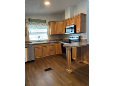 THIS TWO BEDROOM TWO BATH HOME SITS ON THE GOLF COURSE WITH A on Silver Dollar Golf and Trap Club in Florida - for sale on GolfHomes.com, golf home, golf lot