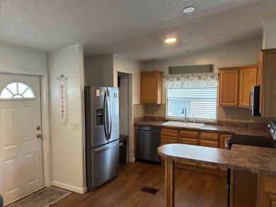 THIS TWO BEDROOM TWO BATH HOME SITS ON THE GOLF COURSE WITH A on Silver Dollar Golf and Trap Club in Florida - for sale on GolfHomes.com, golf home, golf lot