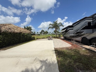 This prime pull-in lot offers breathtaking golf course and water on Motorcoach Resort Golf Course in Florida - for sale on GolfHomes.com, golf home, golf lot
