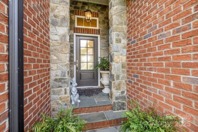 Grand arched stone entry with slate steps and covered porch on Cramer Mountain Country Club in North Carolina - for sale on GolfHomes.com, golf home, golf lot