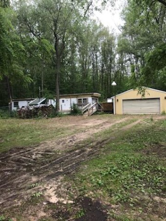 Beautiful wooded lot with 1970 single wide mobile home. The on Pilgrims Run Golf Club in Michigan - for sale on GolfHomes.com, golf home, golf lot