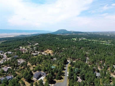 Nestled in the peaceful forest of Larkspur, CO, this mountain on The Golf Club At Bear Dance in Colorado - for sale on GolfHomes.com, golf home, golf lot