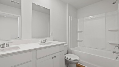 This two-story plan boasts a luxurious primary bedroom upstairs on Shannon Greens Golf Course in South Carolina - for sale on GolfHomes.com, golf home, golf lot