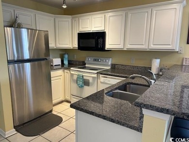 This corner unit golf course condo is tucked away in a serene on True Blue Plantation in South Carolina - for sale on GolfHomes.com, golf home, golf lot