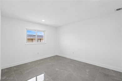 This stunning Renovated home IS STURDY AS STEEL AND NOTHING TO on Port Charlotte Golf Club in Florida - for sale on GolfHomes.com, golf home, golf lot