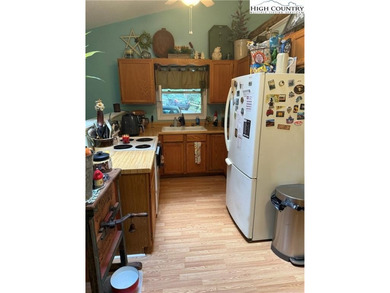 Welcome to 61 River Loop, a charming mountain retreat nestled on Land Harbor Golf Course in North Carolina - for sale on GolfHomes.com, golf home, golf lot