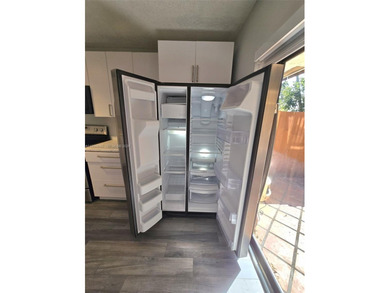 Wake up every morning to a serene golf course and water views in on Pine Island Ridge Country Club in Florida - for sale on GolfHomes.com, golf home, golf lot