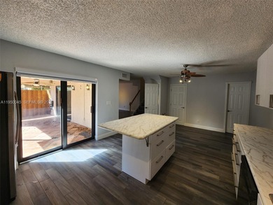 Wake up every morning to a serene golf course and water views in on Pine Island Ridge Country Club in Florida - for sale on GolfHomes.com, golf home, golf lot