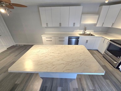 Wake up every morning to a serene golf course and water views in on Pine Island Ridge Country Club in Florida - for sale on GolfHomes.com, golf home, golf lot