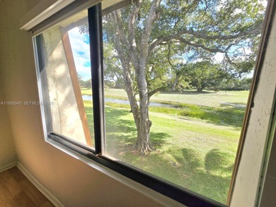 Wake up every morning to a serene golf course and water views in on Pine Island Ridge Country Club in Florida - for sale on GolfHomes.com, golf home, golf lot