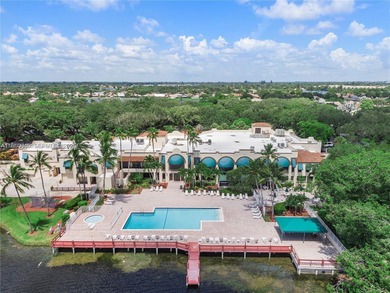 Wake up every morning to a serene golf course and water views in on Pine Island Ridge Country Club in Florida - for sale on GolfHomes.com, golf home, golf lot