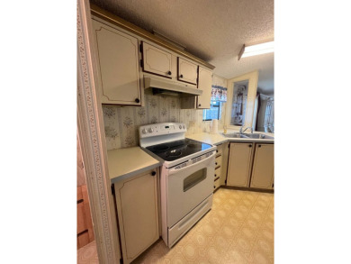 Take a look at this charming and spacious partially furnished on Lake Henry Golf Club in Florida - for sale on GolfHomes.com, golf home, golf lot
