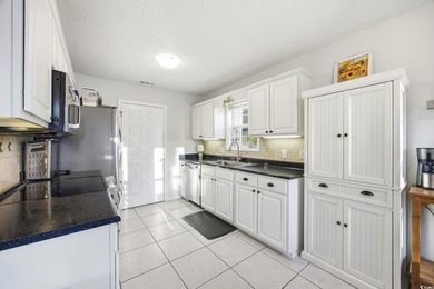 Welcome home to this warm and inviting 4-bedroom, 2-bath home on Palmetto Greens Golf and Country Club in South Carolina - for sale on GolfHomes.com, golf home, golf lot