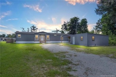 Step into luxury with this stunning custom-built manufactured on The National Golf Club of Louisiana in Louisiana - for sale on GolfHomes.com, golf home, golf lot