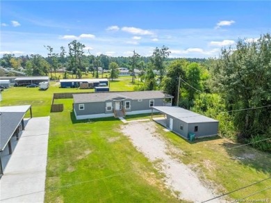 Step into luxury with this stunning custom-built manufactured on The National Golf Club of Louisiana in Louisiana - for sale on GolfHomes.com, golf home, golf lot