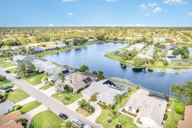 Drive up the pavered circular driveway framed by lush on Baytree National Golf Links in Florida - for sale on GolfHomes.com, golf home, golf lot