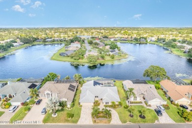 Drive up the pavered circular driveway framed by lush on Baytree National Golf Links in Florida - for sale on GolfHomes.com, golf home, golf lot