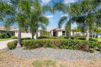 Drive up the pavered circular driveway framed by lush on Baytree National Golf Links in Florida - for sale on GolfHomes.com, golf home, golf lot