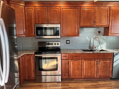 This spacious 3 bedroom unit features a gorgeous updated kitchen on Myerlee Country Club in Florida - for sale on GolfHomes.com, golf home, golf lot