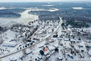 Cozy up to the crackle of the real wood fireplace in this home on Lake McBride Golf Course in Iowa - for sale on GolfHomes.com, golf home, golf lot