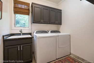 This custom property is tucked away on a quiet cul-de-sac is in on Oakhurst Golf and Country Club in Michigan - for sale on GolfHomes.com, golf home, golf lot