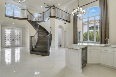 Beautiful home with a waterfront and golf course view! This home on Jupiter Country Club in Florida - for sale on GolfHomes.com, golf home, golf lot