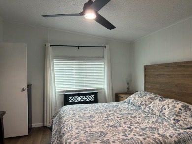 THIS TWO BEDROOM TWO BATH HOME SITS ON THE GOLF COURSE WITH A on Silver Dollar Golf and Trap Club in Florida - for sale on GolfHomes.com, golf home, golf lot