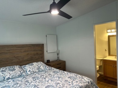 THIS TWO BEDROOM TWO BATH HOME SITS ON THE GOLF COURSE WITH A on Silver Dollar Golf and Trap Club in Florida - for sale on GolfHomes.com, golf home, golf lot