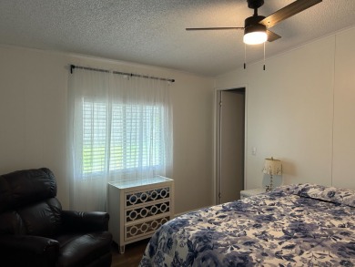 THIS TWO BEDROOM TWO BATH HOME SITS ON THE GOLF COURSE WITH A on Silver Dollar Golf and Trap Club in Florida - for sale on GolfHomes.com, golf home, golf lot
