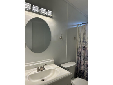 THIS TWO BEDROOM TWO BATH HOME SITS ON THE GOLF COURSE WITH A on Silver Dollar Golf and Trap Club in Florida - for sale on GolfHomes.com, golf home, golf lot