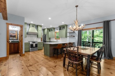 Located in Sapphire Valley, this 3-bedroom, 2.5-bathroom cabin on Sapphire National Golf Club in North Carolina - for sale on GolfHomes.com, golf home, golf lot