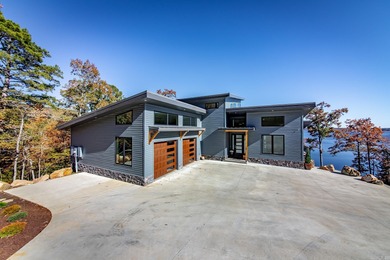 Breathtaking Modern Lakefront Retreat with Boat Slip Welcome to on Indian Hills Country Club in Arkansas - for sale on GolfHomes.com, golf home, golf lot