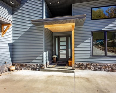 Breathtaking Modern Lakefront Retreat with Boat Slip Welcome to on Indian Hills Country Club in Arkansas - for sale on GolfHomes.com, golf home, golf lot