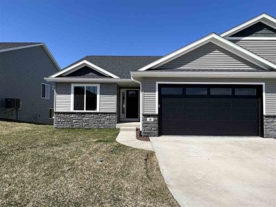 This walkout zero lot has white kitchen cabinets, quartz/granite on Fox Run Golf and Country Club in Iowa - for sale on GolfHomes.com, golf home, golf lot