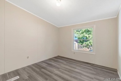 This spacious doublewide offers new  laminate flooring and on River Ridge Golf Club in Virginia - for sale on GolfHomes.com, golf home, golf lot
