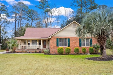 Check out this beautifully landscaped brick and wood exterior on Wedgefield Plantation Golf Club in South Carolina - for sale on GolfHomes.com, golf home, golf lot