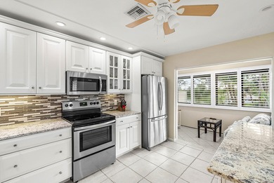 Spacious 3-bedroom, 2-bath condo featuring wood-look tile on Quail Ridge Golf Course and Country Club in Florida - for sale on GolfHomes.com, golf home, golf lot