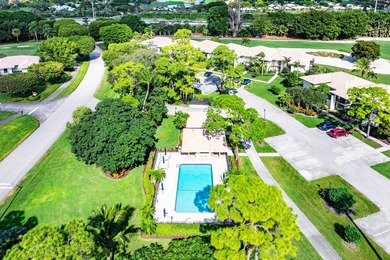 Spacious 3-bedroom, 2-bath condo featuring wood-look tile on Quail Ridge Golf Course and Country Club in Florida - for sale on GolfHomes.com, golf home, golf lot
