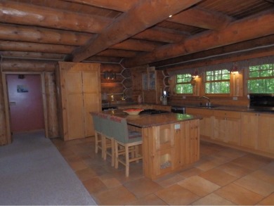 This stunning log home located on the 6th tee of Garland's on Garland Resort and Golf Club  in Michigan - for sale on GolfHomes.com, golf home, golf lot