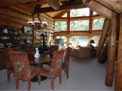 This stunning log home located on the 6th tee of Garland's on Garland Resort and Golf Club  in Michigan - for sale on GolfHomes.com, golf home, golf lot