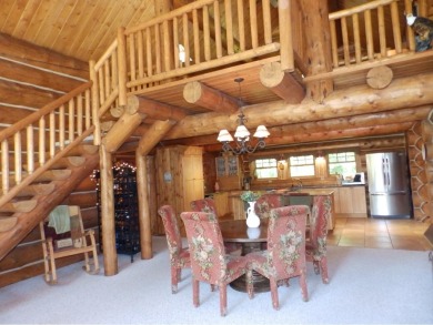 This stunning log home located on the 6th tee of Garland's on Garland Resort and Golf Club  in Michigan - for sale on GolfHomes.com, golf home, golf lot