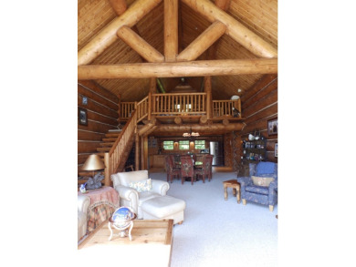 This stunning log home located on the 6th tee of Garland's on Garland Resort and Golf Club  in Michigan - for sale on GolfHomes.com, golf home, golf lot