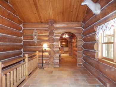 This stunning log home located on the 6th tee of Garland's on Garland Resort and Golf Club  in Michigan - for sale on GolfHomes.com, golf home, golf lot