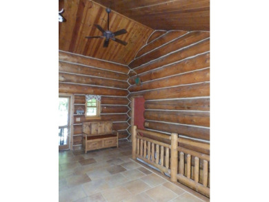 This stunning log home located on the 6th tee of Garland's on Garland Resort and Golf Club  in Michigan - for sale on GolfHomes.com, golf home, golf lot